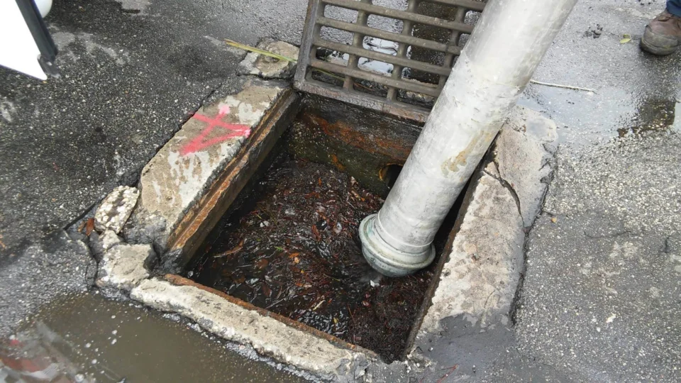 Commercial floor drain and sewer pipe exposed for repair